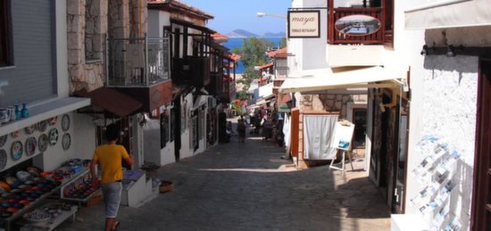 Cobbled street with Kalkan old town with small shop fronts on either side of street